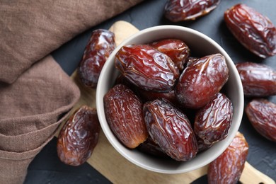 Photo of Tasty dried dates on grey table, top view