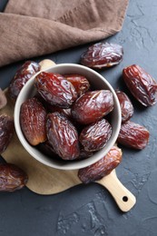 Photo of Tasty dried dates on grey table, top view