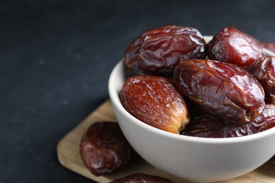 Photo of Tasty dried dates on grey table, closeup. Space for text