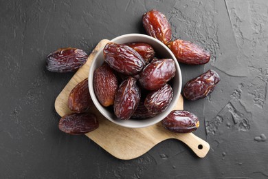 Photo of Tasty dried dates on grey table, top view