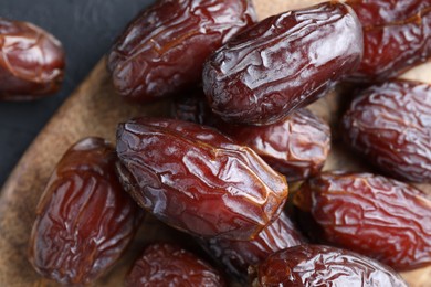 Photo of Tasty dried dates on grey table, top view