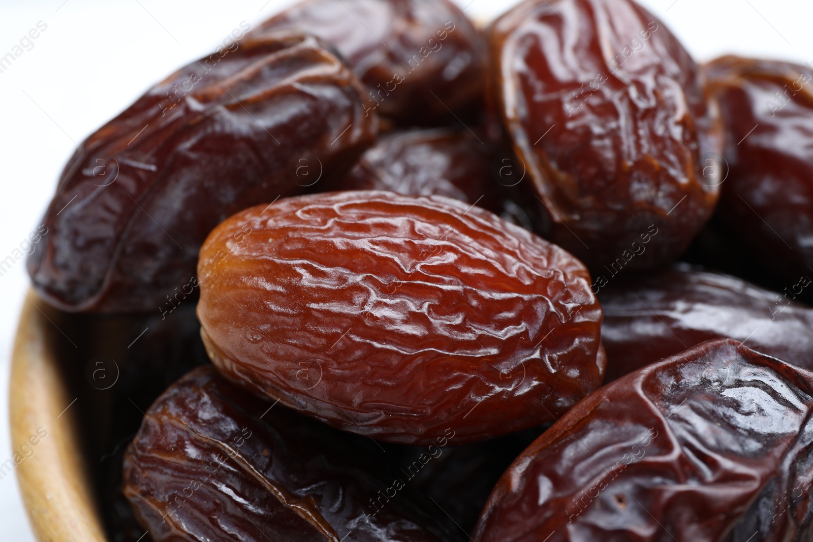 Photo of Many tasty dried dates in bowl, closeup