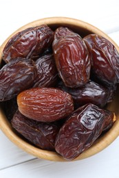 Photo of Tasty dried dates on white table, top view