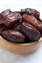 Photo of Tasty dried dates on white table, closeup