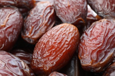 Photo of Many tasty dried dates as background, closeup