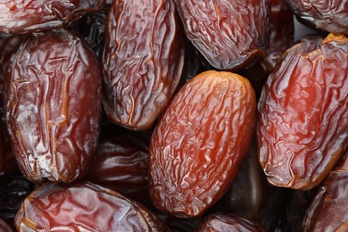 Photo of Many tasty dried dates as background, closeup