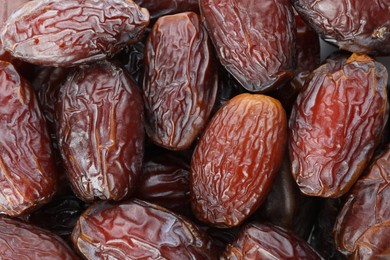 Photo of Many tasty dried dates as background, closeup