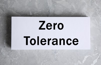 Image of Zero Tolerance concept. Paper with words on grey background