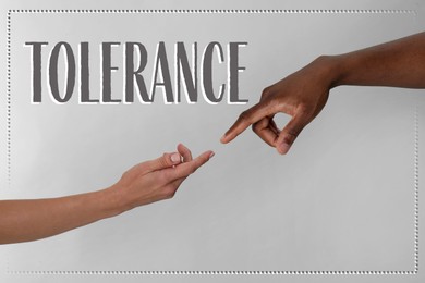 Image of Tolerance concept. Woman and African American man touching fingers on grey background, closeup