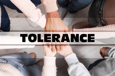 Image of Tolerance concept. Group of multiracial people joining hands together, top view