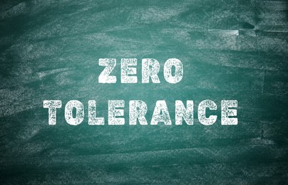 Image of Zero Tolerance concept. Words on green chalkboard