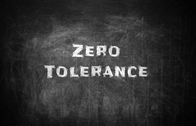 Image of Zero Tolerance concept. Words on black chalkboard