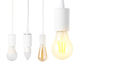 Image of Different light bulbs hanging on white background. Banner design with space for text