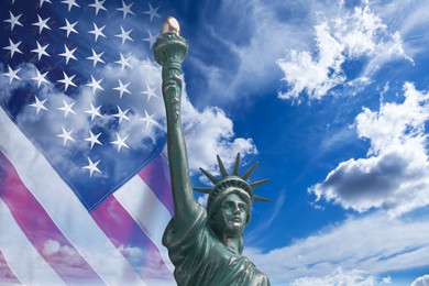 Image of Statue of Liberty against American flag and sky