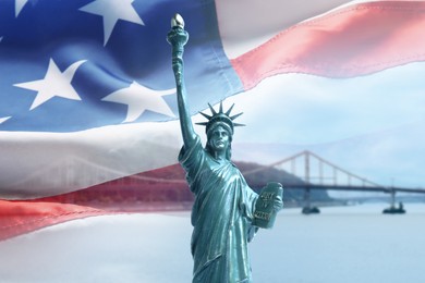 Image of Statue of Liberty against American flag and bridge