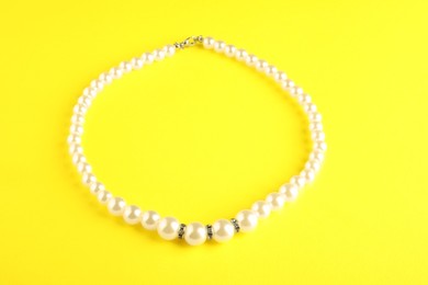 Beautiful bijouterie. Stylish bracelet on yellow background