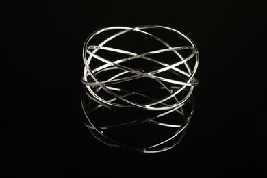 Beautiful bijouterie. Elegant bracelet on black mirror surface, closeup