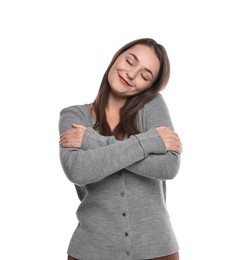 Photo of Beautiful young woman hugging herself on white background