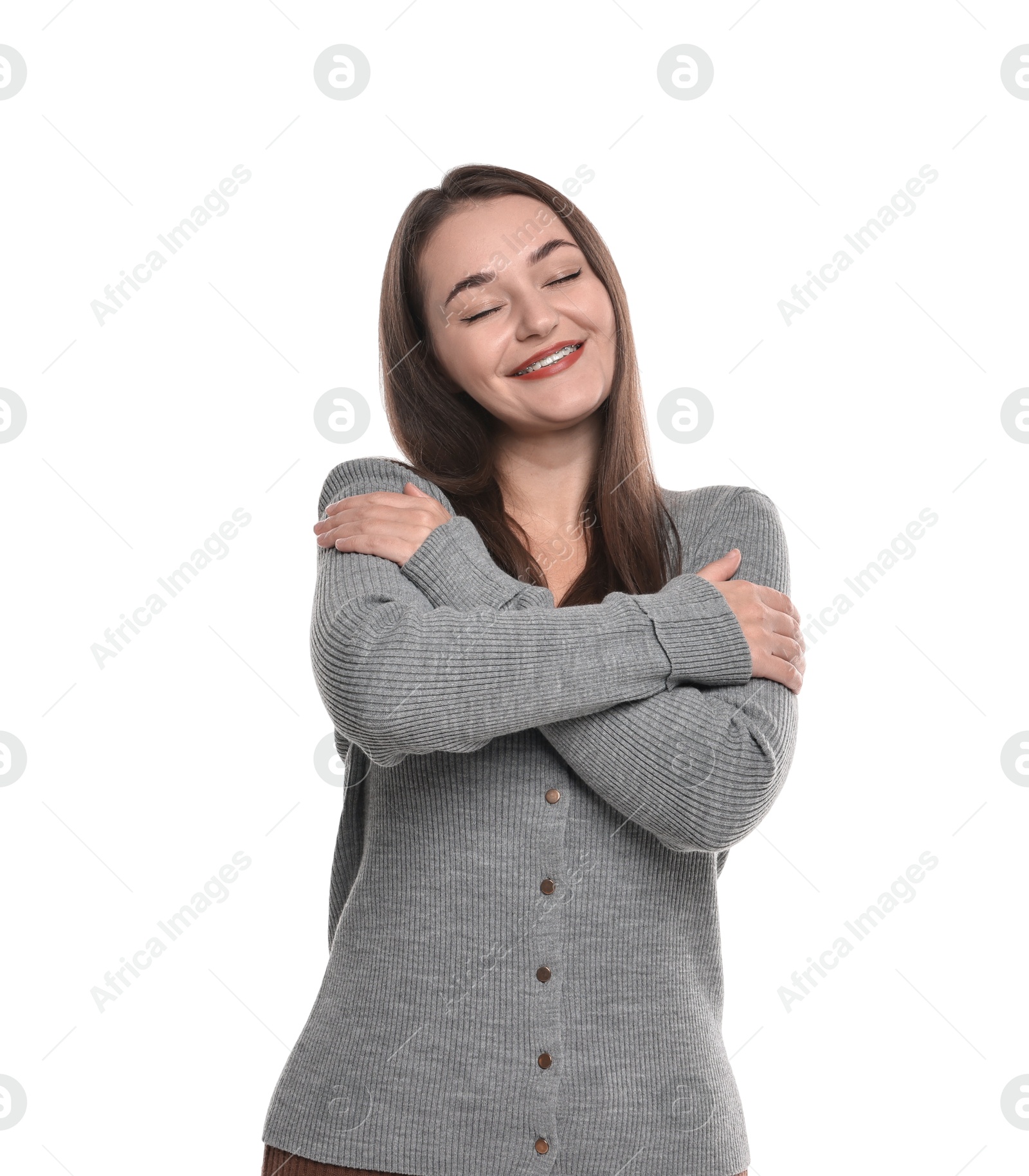 Photo of Beautiful young woman hugging herself on white background