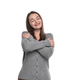 Photo of Beautiful young woman hugging herself on white background