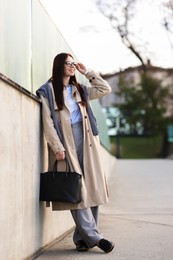 Photo of Smiling businesswoman in stylish suit on city street