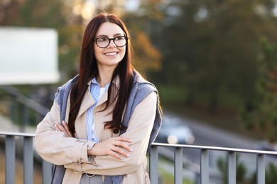 Photo of Beautiful woman in stylish suit outdoors. Space for text