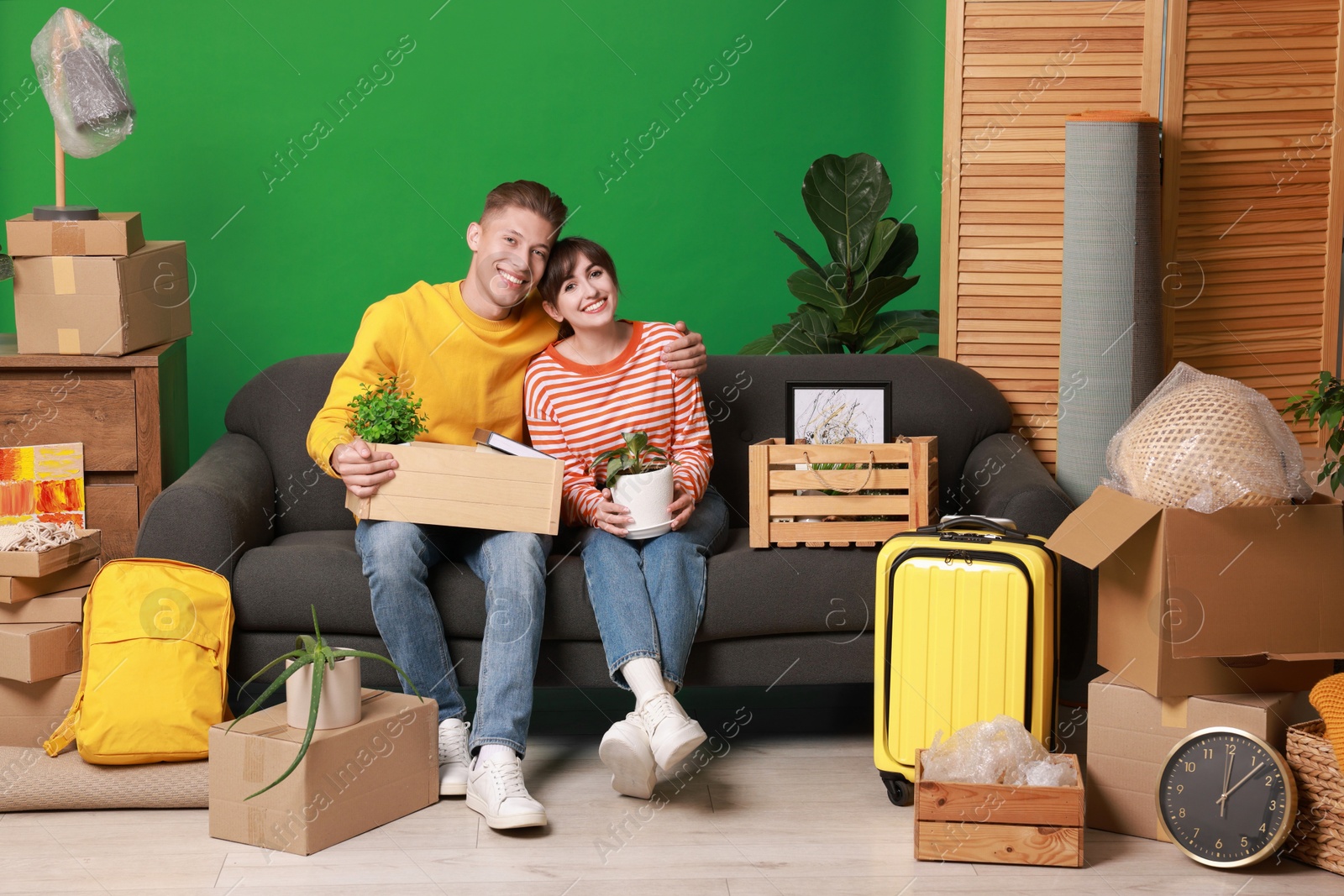 Photo of Happy couple with different stuff in new apartment. Housewarming party