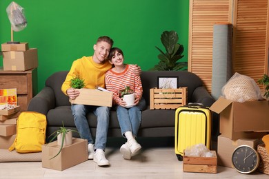 Photo of Happy couple with different stuff in new apartment. Housewarming party