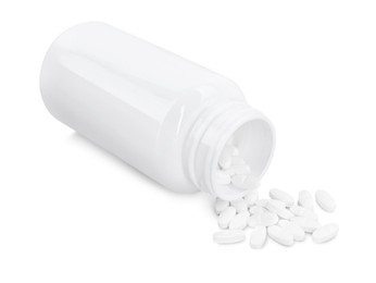 Photo of Antibiotic pills with medical bottle on white background