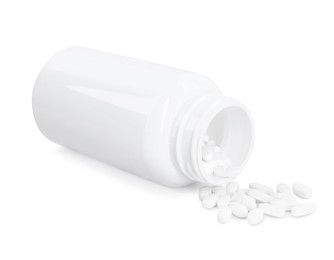 Photo of Antibiotic pills with medical bottle on white background