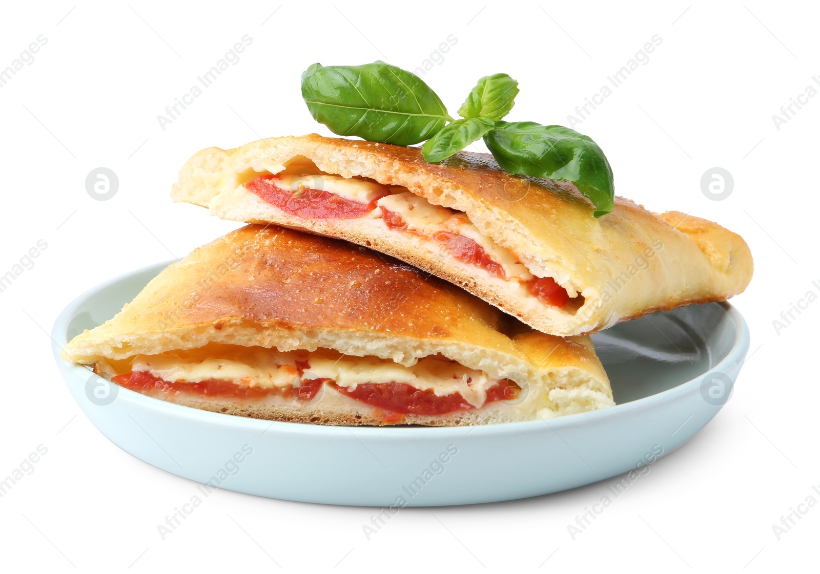 Photo of Pieces of tasty vegetarian calzone with tomato, cheese and basil isolated on white