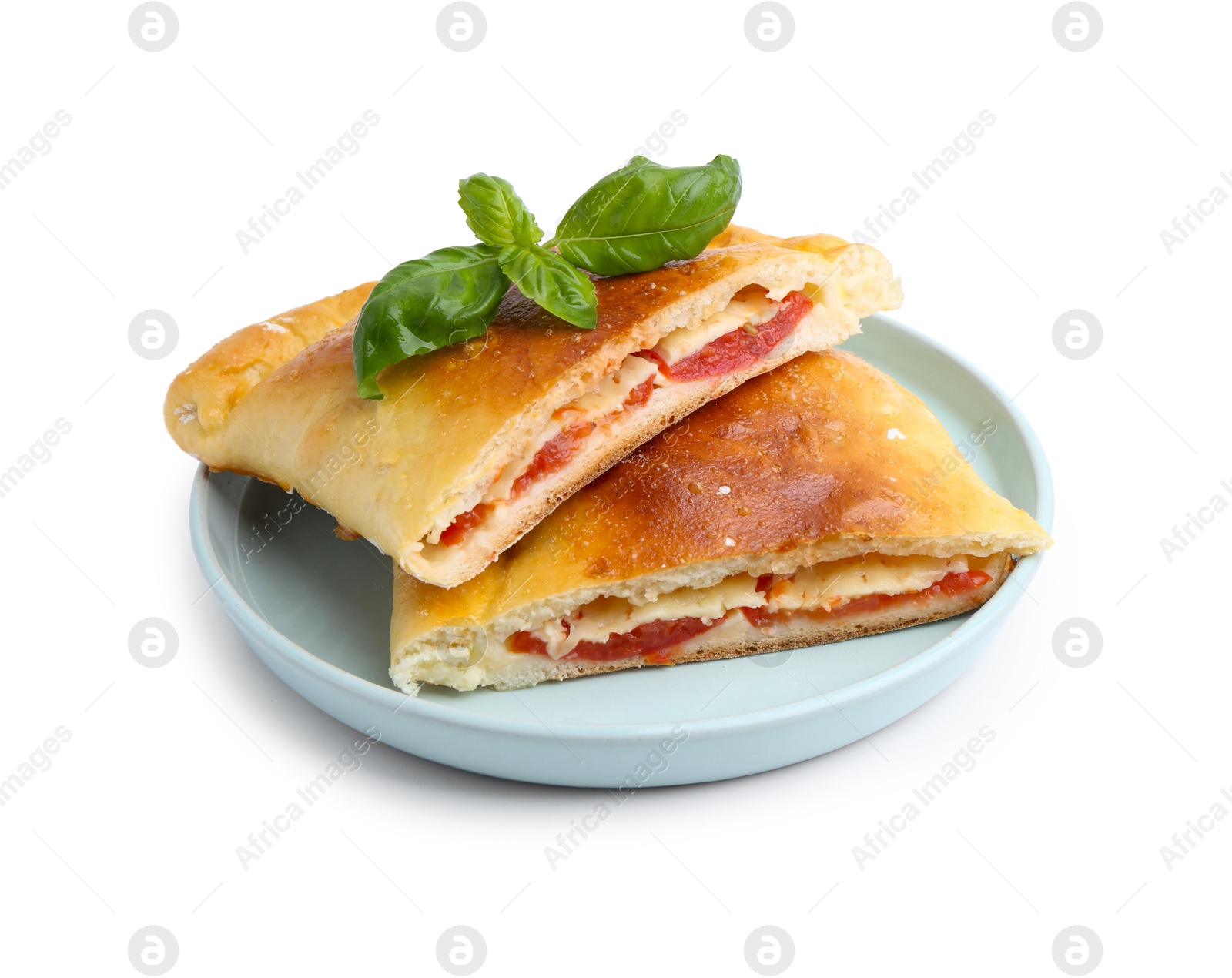 Photo of Pieces of tasty vegetarian calzone with tomato, cheese and basil isolated on white