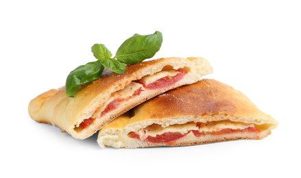 Photo of Pieces of tasty vegetarian calzone with tomato, cheese and basil isolated on white