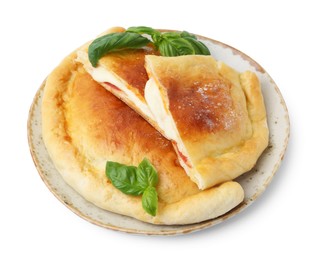 Photo of Pieces of delicious calzone pizza with mozzarella, tomatoes and basil isolated on white