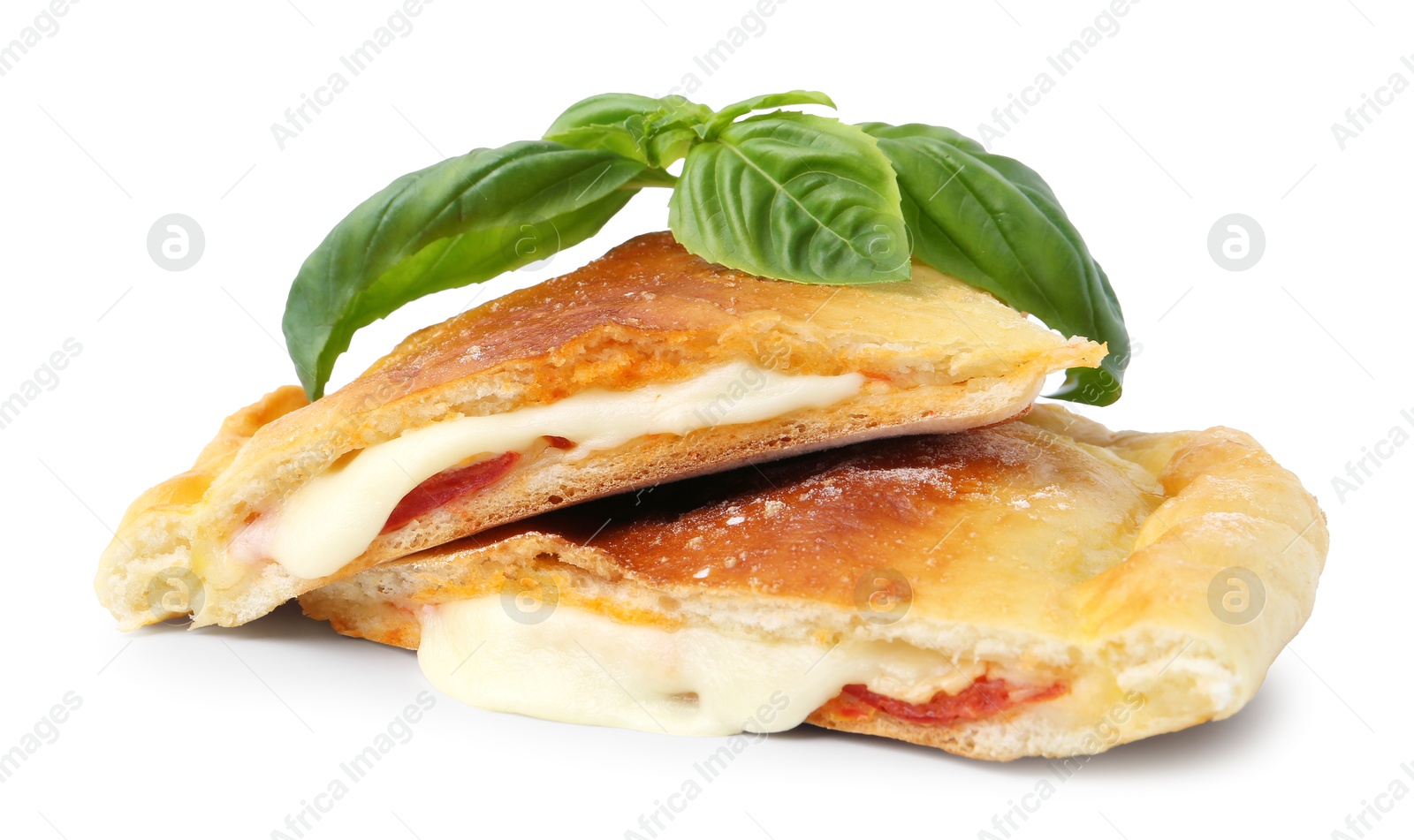 Photo of Pieces of delicious calzone pizza with mozzarella, tomatoes and basil isolated on white