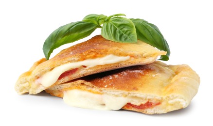 Photo of Pieces of delicious calzone pizza with mozzarella, tomatoes and basil isolated on white