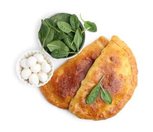 Photo of Tasty calzones with basil and mozzarella cheese isolated on white, top view