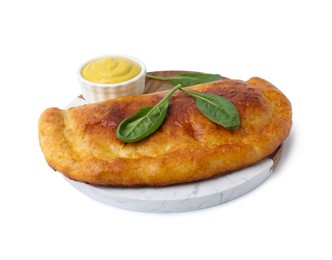 Photo of Tasty calzone with basil and sauce isolated on white