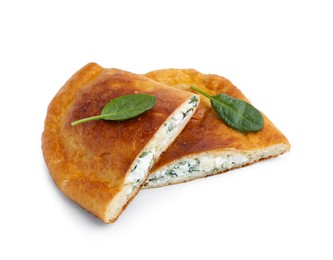 Photo of Pieces of tasty calzone with cheese and basil isolated on white