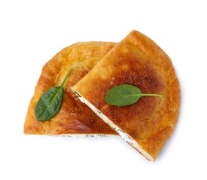 Photo of Pieces of tasty calzone with cheese and basil isolated on white, top view