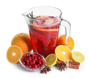 Photo of Aromatic punch drink in glass jug and ingredients on white background