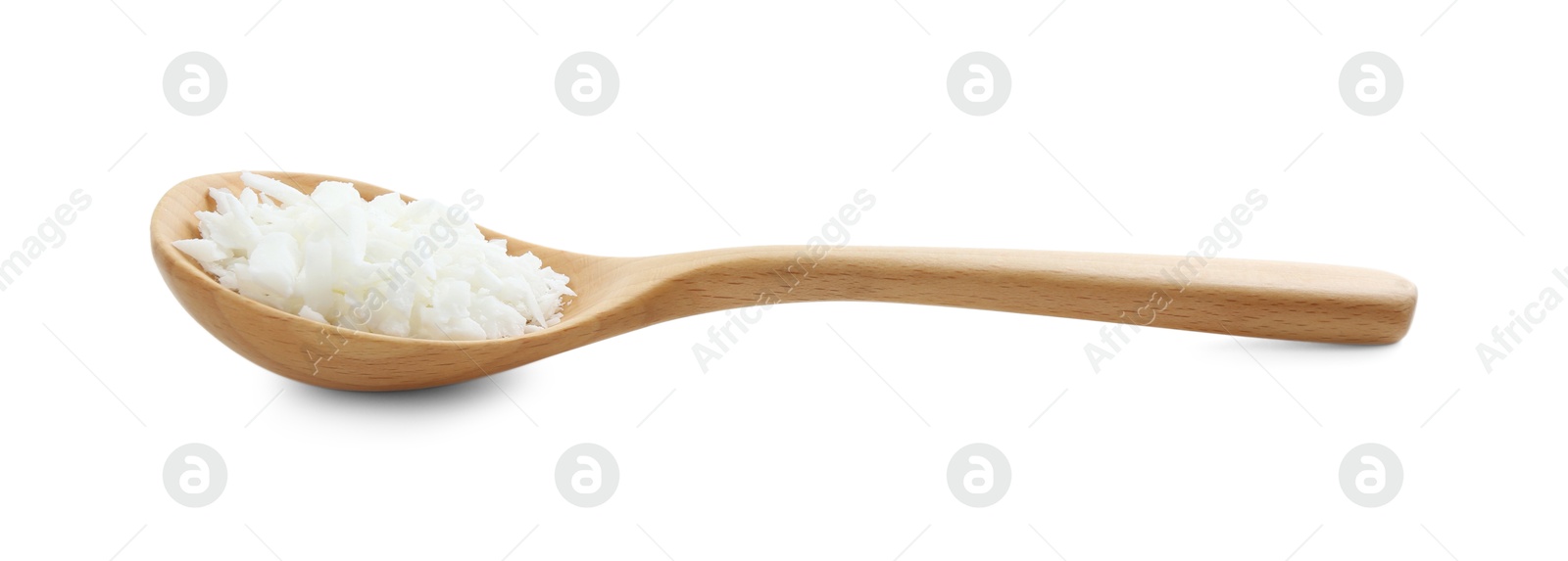 Photo of Soy wax in wooden spoon isolated on white