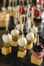 Photo of Many different tasty canapes on table, closeup