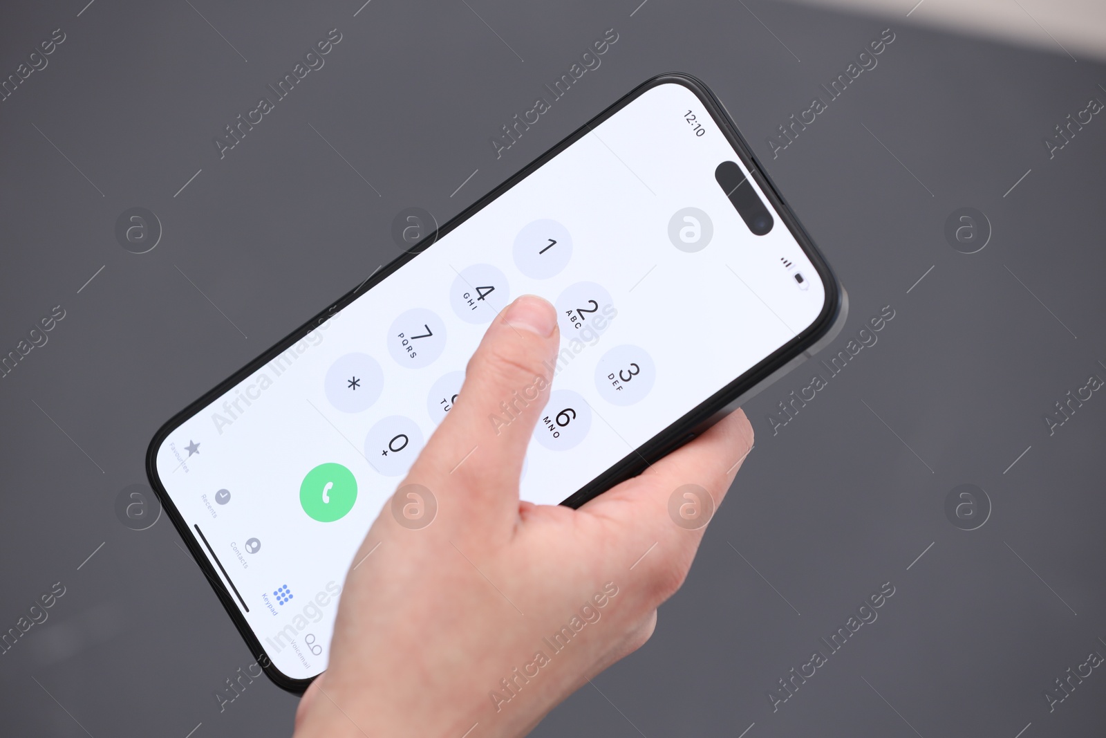 Photo of Woman dialing number on smartphone against blurred grey background, closeup