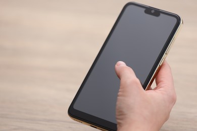 Photo of Woman using smartphone with blank screen against blurred background, closeup. Space for text