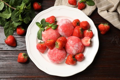 Photo of Delicious mochi, strawberries and mint on wooden table, flat lay