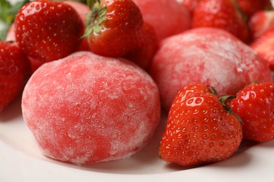 Photo of Delicious mochi and strawberries on plate, closeup