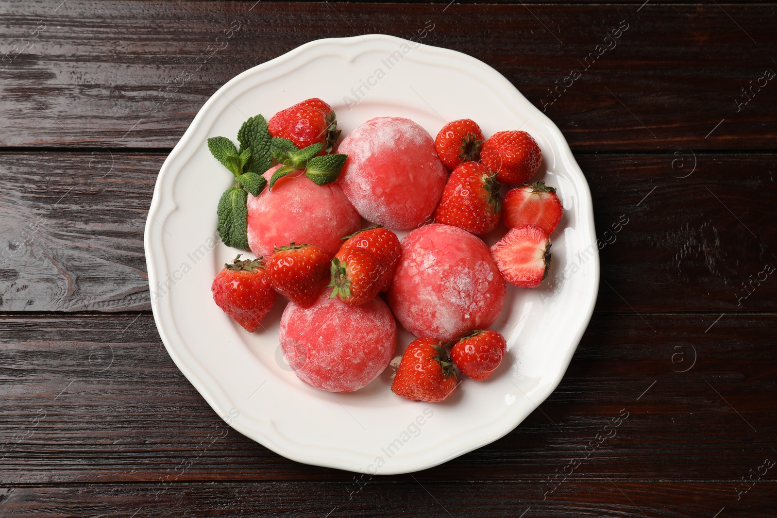 Photo of Delicious mochi, strawberries and mint on wooden table, top view