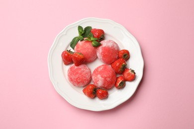 Photo of Delicious mochi, strawberries and mint on pink background, top view