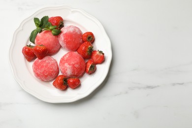 Photo of Delicious mochi, strawberries and mint on white marble table, top view. Space for text